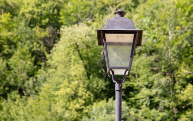 Old lantern in the park during the day.