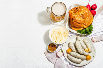 Traditional Oktoberfest set. Beer, weisswurst, smoked pork knuckle eisbein with fermented cabbage