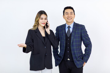 Millennial Asian cheerful successful professional male businessman manager female businesswoman colleague in formal suit standing smiling holding using laptop computer together on white background