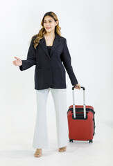 Isolated cutout studio full body shot of Millennial Asian successful professional female businesswoman in formal suit walking holding pulling trolley luggage for business trip on white background