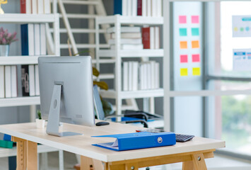 Workstation wooden working table with computer monitor, keyboard, mouse, document folders,...