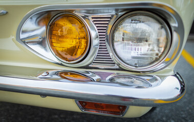 Vintage Car Front Detail. Classic car headlights close-up. Headlights of yellow vintage car. Exhibition