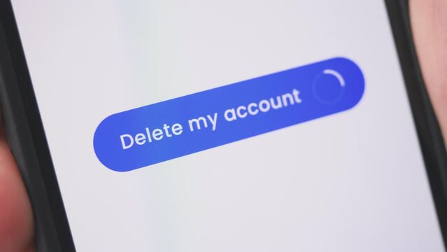 Young lady pressing delete my account button on smartphone. Social media, privacy and addiction concept.