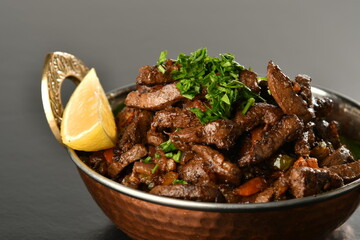 beef liver, served dry or with curry in a bowl, karahi or plate
