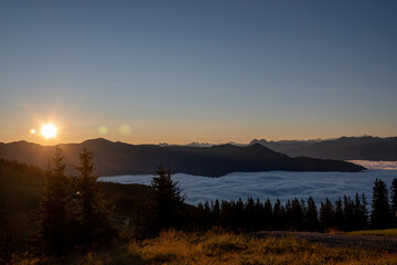 beautiful sunrise on the mountains with view of the alps and a misty valley at  autumn morning