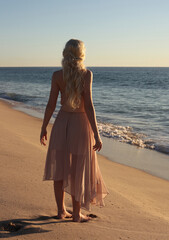 full length portrait of beautiful young woman with long hair wearing flowing dress, standing pose...