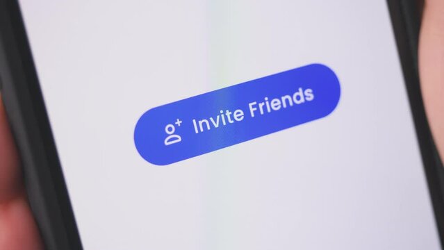 Young lady pressing invite friends button on smartphone. Social media concept.