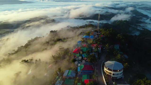 Aerial shot of Lushai heritage village and Sajek valley on a foggy day in the morning