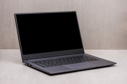 black mock up on a laptop screen on a gray background close up with clipping path