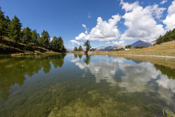 panoramic view of Lake Laune in the high mountains of the Alps of Piedmont. Susa Valley, Wood of...