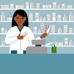Pharmacist at the pharmacy behind the counter. A female pharmacist holds medicines in his hand.