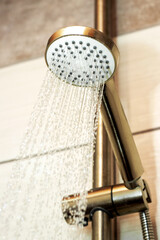 The flow of water from the watering can in the shower, close-up. Taking a shower