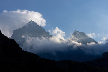 the top of Monviso emerging from the clouds. Cottian Alps, Pian della Regina, Piedmont, Italy