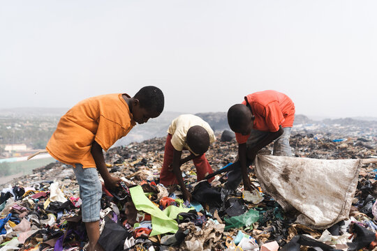 Group of street children collecting garbage in a landfill in an African metropolis