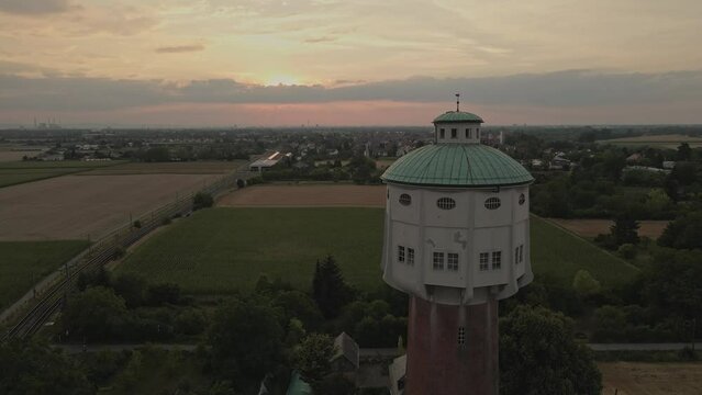 Slow Drone flying past the Water Tower at Ladenburg  around the Rhein-Neckar towards the pink sky