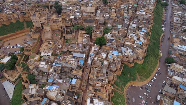 Drone flying backwards revealing Jaisalmer fort in the Indian state of Rajasthan. One of the very few living forts in the world