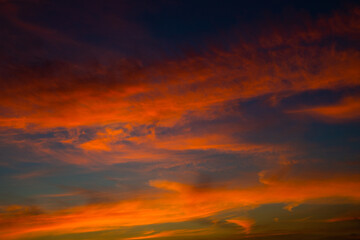 Fototapeta premium Beautiful red clouds in the dark blue sky, summer sunset