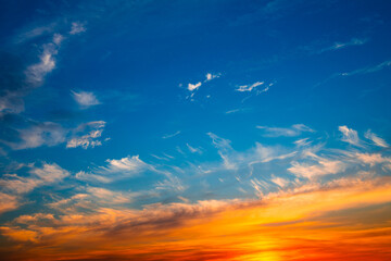Beautiful orange clouds in blue sunset sky - 530991405