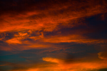 Beautiful red clouds in the dark blue sky, summer sunset