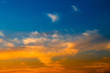 Naklejka na ściany i meble Beautiful yellow clouds in blue sunset sky