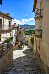 A narrow street between the old stone houses of Pescocostanzo, a medieval village in the Abruzzo region of Italy.