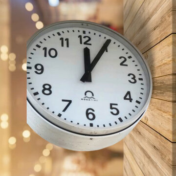 Big clock showing five past twelve - symbolic picture