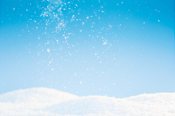 Snow on the ground, snow in blue sky and sunshine - Christmas and winter holiday texture background