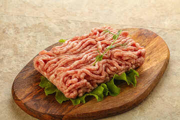 Raw minced pork meat over board