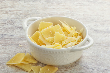 Sliced parmesan cheese heap in the bowl