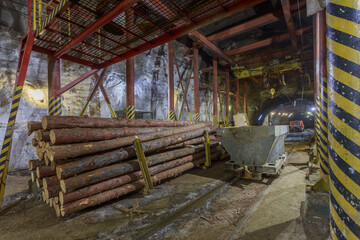 Fototapeta premium Dark tunnel of kimberlite mine with railroad.