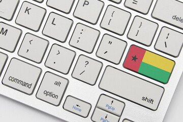 national flag of guinea bissau on the keyboard on a grey background .3d illustration