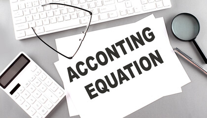 ACCOUNTING EQUATION text on paper with keyboard, calculator on grey background