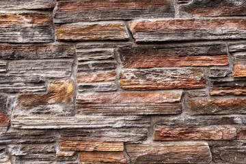 Stone wall surface texture. Background for design purpose. Red color tone of rocks.
