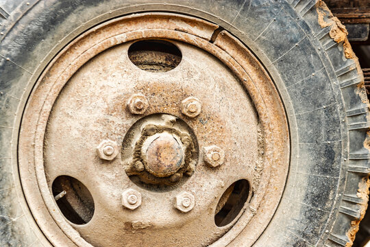 Wheel of an old truck close-up. Rusted rim.