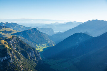 Fototapeta premium view over Diemtigtal on a summer morning with Lake Thun in the distance