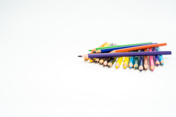 wooden colored pencils on a white background with a point (lead) in focus