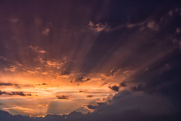 Beautiful sun beams in a sky over dramatic stormy clouds - 531000822