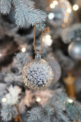 silver christmas ball on branch