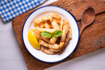 Traditional spanish tapa. Rabas, tasty fried squid with lemon.