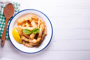 Traditional spanish tapa. Rabas, tasty fried squid with lemon.