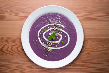 Red cabbage cream decorated with liquid cream