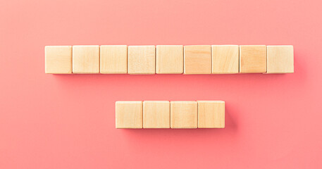 Wooden toy blocks on soft pink background
