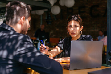 Two young business people woprking together