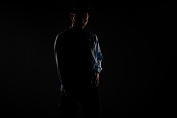 Male model posing in a light dimmed room