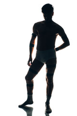 Fototapeta na wymiar Strong handsome silhouette fitness sports man in underwear