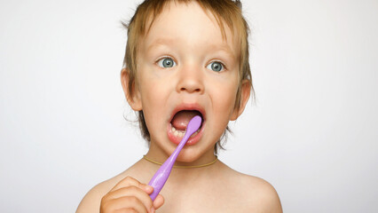 A portrait of a cute boy brushing his teeth