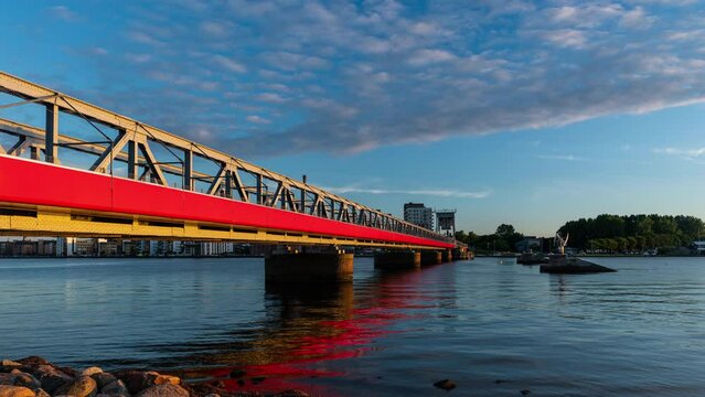 Time Lapse of the Cultural Bridge - a train and pedestrian bridge in Aalborg, Denmark, during a colorful sunset
