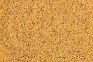 Raw bulgur food background. Dry bulgur grain. Healthy eating. Organic product. Top view.