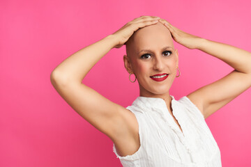 Fototapeta premium Woman with cancer optimistic after chemotherapy touches her hairless head