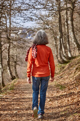 Woman walking in the woods. Healthy lifestyle. Natural environment